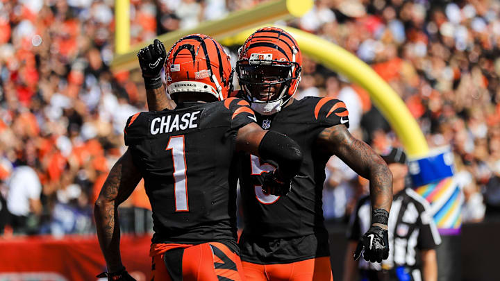Oct 6, 2024; Cincinnati, Ohio, USA; Cincinnati Bengals wide receiver Tee Higgins (5) reacts after wide receiver Ja'Marr Chase (1) scored a touchdown against the Baltimore Ravens in the first half at Paycor Stadium. Mandatory Credit: Katie Stratman-Imagn Images