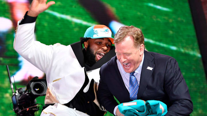 Christian Wilkins celebrates his pick by the Miami Dolphins with NFL Commissioner Roger Goodell during the first round of the NFL Draft Thursday, April 25, 2019, in Nashville, Tenn.