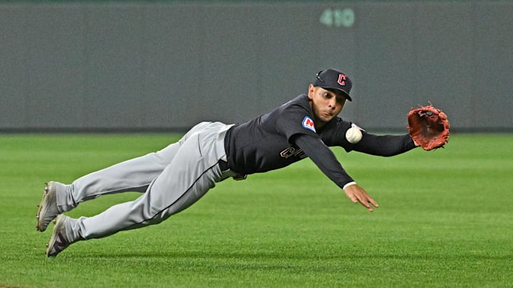 Jun 27, 2024; Kansas City, Missouri, USA;  Cleveland Guardians second baseman Andres Gimenez (0) makes a diving play on a ground ball in the ninth inning against the Kansas City Royals at Kauffman Stadium. Mandatory Credit: Peter Aiken-Imagn Images