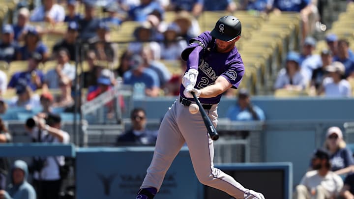 Sep 22, 2024; Los Angeles, California, USA;  Colorado Rockies third baseman Ryan McMahon (24) hits a single during the first inning against the Los Angeles Dodgers at Dodger Stadium. Mandatory Credit: Kiyoshi Mio-Imagn Images