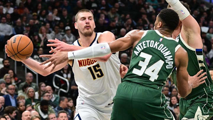 Feb 27, 2025; Milwaukee, Wisconsin, USA; Denver Nuggets center Nikola Jokic (15) looks to pass the ball away from Milwaukee Bucks forward Giannis Antetokounmpo (34) in the third quarter at Fiserv Forum. Mandatory Credit: Benny Sieu-Imagn Images Feb 27, 2025; Milwaukee, Wisconsin, USA; Denver Nuggets center Nikola Jokic (15) looks to pass the ball away from Milwaukee Bucks forward Giannis Antetokounmpo (34) in the third quarter at Fiserv Forum. Mandatory Credit: Benny Sieu-Imagn Images