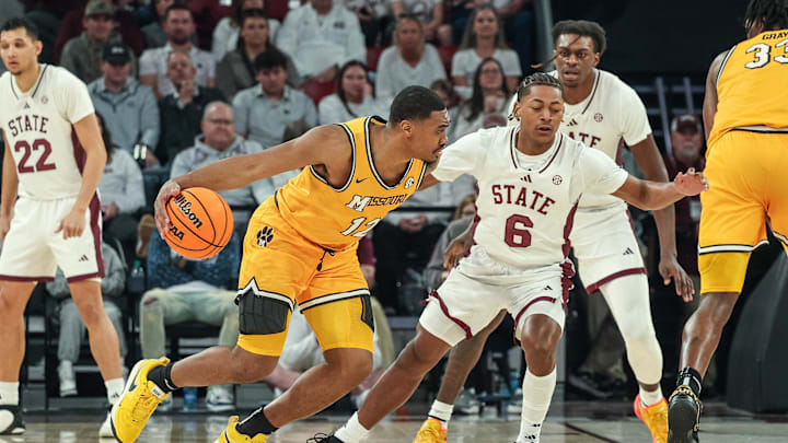 Feb 1, 2025; Starkville, Mississippi, USA; Missouri Tigers guard Tony Perkins (12) drives to the basket against Mississippi State Bulldogs guard Dellquan Warren (6) during the second half at Humphrey Coliseum. Mandatory Credit: Wesley Hale-Imagn Images Feb 1, 2025; Starkville, Mississippi, USA; Missouri Tigers guard Tony Perkins (12) drives to the basket against Mississippi State Bulldogs guard Dellquan Warren (6) during the second half at Humphrey Coliseum. Mandatory Credit: Wesley Hale-Imagn Images