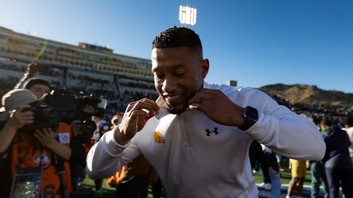 Notre Dame head football coach Marcus Freeman shakes off Frosted Flakes from his shirt after his
