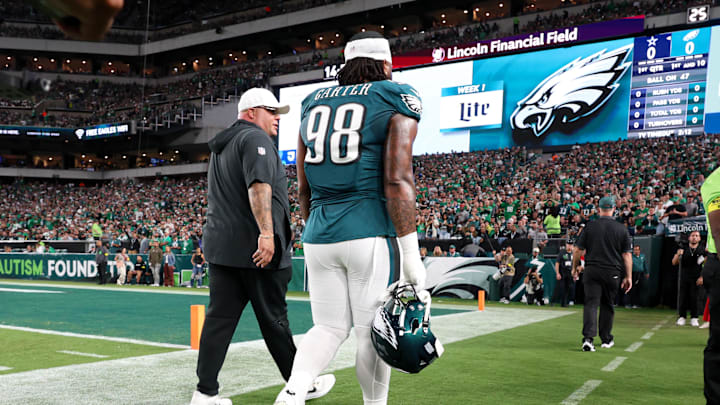 Sep 4, 2025; Philadelphia, Pennsylvania, USA; Philadelphia Eagles defensive tackle Jalen Carter (98) walks off the field with Eagles chief security officer Dom DiSandro (L) after being ejected from the game against the Dallas Cowboys at Lincoln Financial Field. Mandatory Credit: Bill Streicher-Imagn Images