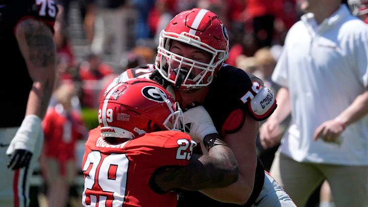 Georgia defensive lineman Isaiah Gibson (29) warms up with Georgia offensive lineman Mason Short (75) before the start of the Georgia G-Day spring football game in Athens, Ga., on Saturday, April 12, 2025.