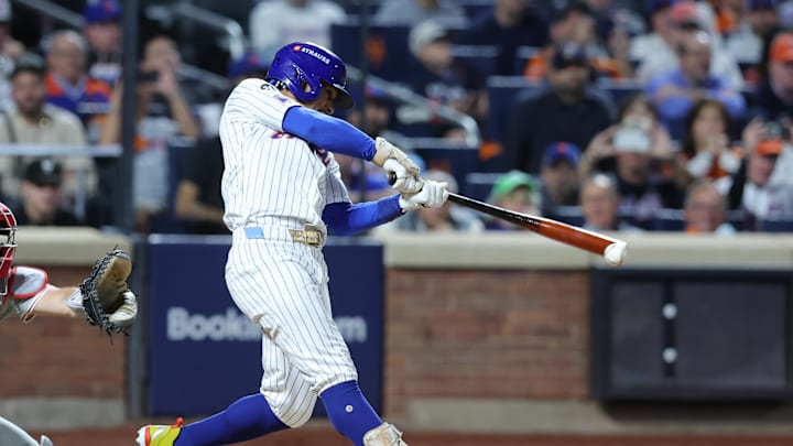 New York Mets shortstop Francisco Lindor (12) hits an RBI double against the Philadelphia Phillies in the eighth inning during game three of the NLDS for the 2024 MLB Playoffs at Citi Field on Oct 8.
