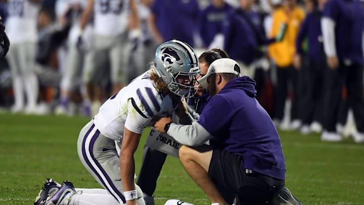 Oct 12, 2024; Boulder, Colorado, USA; Kansas State Wildcats quarterback Avery Johnson (2) is helped off the field after an injury during the second half against the Colorado Buffaloes at Folsom Field. Mandatory Credit: Christopher Hanewinckel-Imagn Images