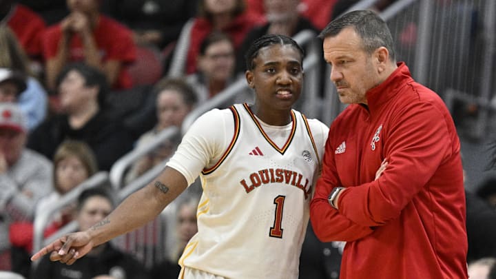 Feb 5, 2026; Louisville, Kentucky, USA;  Louisville Cardinals guard Reyna Scott (1) talks with head coach Jeff Walz during the second half against the Duke Blue Devils at KFC Yum! Center. Duke defeated Louisville 59-58. Mandatory Credit: Jamie Rhodes-Imagn Images