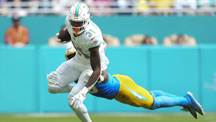 Los Angeles Chargers free safety Derwin James (3) tackles Miami Dolphins running back Ollie Gordon II (31) during the third quarter at Hard Rock Stadium. Los Angeles Chargers free safety Derwin James (3) tackles Miami Dolphins running back Ollie Gordon II (31) during the third quarter at Hard Rock Stadium.