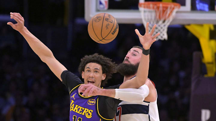 Jan 21, 2025; Los Angeles, California, USA;  Los Angeles Lakers center Jaxson Hayes (11) and Washington Wizards center Jonas Valanciunas (17) reach for a pass in the first half at Crypto.com Arena. Mandatory Credit: Jayne Kamin-Oncea-Imagn Images