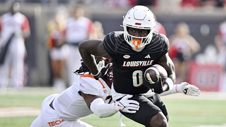 Nov 4, 2023; Louisville, Kentucky, USA;  Louisville Cardinals wide receiver Chris Bell (0) runs the ball against the Virginia Tech Hokies during the first quarter at L&N Federal Credit Union Stadium. Mandatory Credit: Jamie Rhodes-Imagn Images