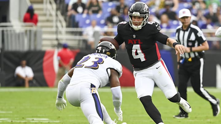 Aug 17, 2024; Baltimore, Maryland, USA;  Atlanta Falcons quarterback Taylor Heinicke (4) attempted to rush by  Baltimore Ravens linebacker Trenton Simpson (23) during the first half at M&T Bank Stadium. Mandatory Credit: Tommy Gilligan-Imagn Images