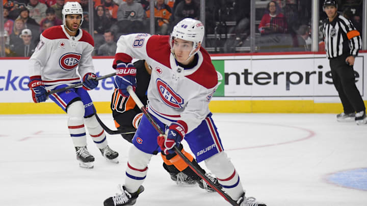 Mar 27, 2025; Philadelphia, Pennsylvania, USA; Montreal Canadiens defenseman Lane Hutson (48) clears the puck against the Philadelphia Flyers during the first period at Wells Fargo Center. Mandatory Credit: Eric Hartline-Imagn Images