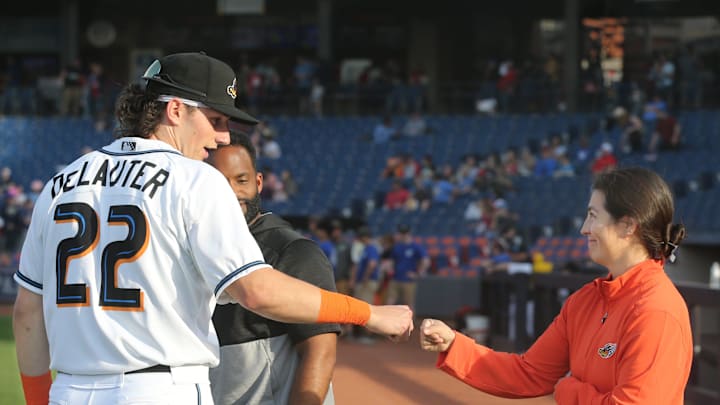 Akron RubberDucks assistant athletic trainer Karina Gonzalez gets a first bump from Chase DeLauter before the game against Erie on Tuesday, April 16, 2024, in Akron, Ohio. [Phil Masturzo/ Beacon Journal]