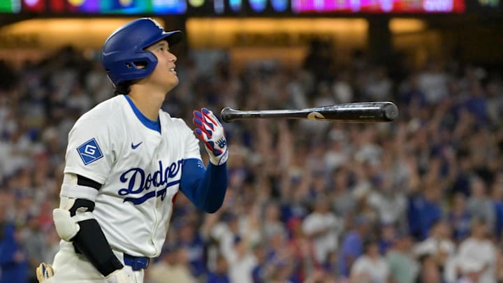 Sep 16, 2025; Los Angeles, California, USA;  Los Angeles Dodgers designated hitter Shohei Ohtani (17) flips his bat after hitting his 50th home run of the season during the eighth inning against the Philadelphia Phillies at Dodger Stadium. Mandatory Credit: Jayne Kamin-Oncea-Imagn Images