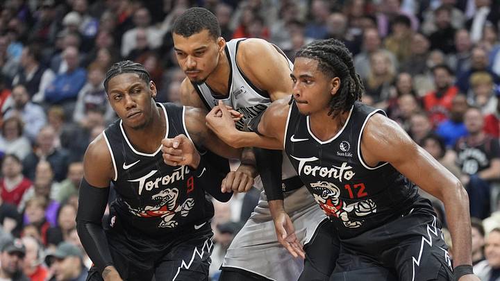 Feb 25, 2026; Toronto, Ontario, CAN; Toronto Raptors forward RJ Barrett (9) and forward Collin Murray-Boyles (12) block out San Antonio Spurs center Victor Wembanyama (1) during the first half at Scotiabank Arena. Mandatory Credit: John E. Sokolowski-Imagn Images