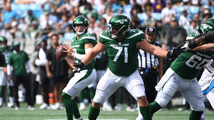 Aug 12, 2023; Charlotte, North Carolina, USA;  New York Jets quarterback Zach Wilson (2) looks to pass as guard Wes Schweitzer (71) blocks in the first quarter at Bank of America Stadium. Mandatory Credit: Bob Donnan-Imagn Images