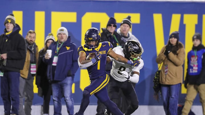 Nov 23, 2024; Morgantown, West Virginia, USA; West Virginia Mountaineers running back Jahiem White (1) runs the ball against the UCF Knights during the third quarter at Mountaineer Field at Milan Puskar Stadium. Mandatory Credit: Ben Queen-Imagn Images
