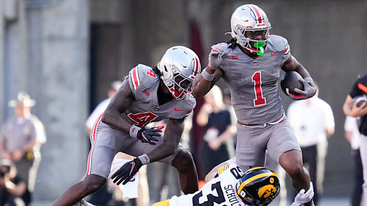 Oct 5, 2024; Columbus, OH, USA; Iowa Hawkeyes defensive back Quinn Schulte (30) tackles Ohio State Buckeyes running back Quinshon Judkins (1) during the first half of the NCAA football game at Ohio Stadium.