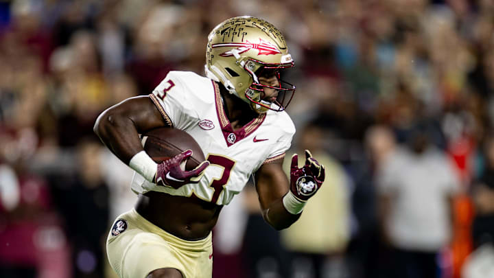 Florida State Seminoles running back Trey Benson (3) rushes with the ball during the first half