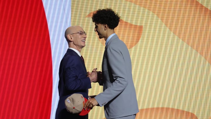 Jun 26, 2024; Brooklyn, NY, USA; Zaccharie Risacher shakes hands with NBA commissioner Adam Silver after being selected first overall by the Atlanta Hawks in the first round of the 2024 NBA Draft at Barclays Center. Mandatory Credit: Brad Penner-USA TODAY Sports