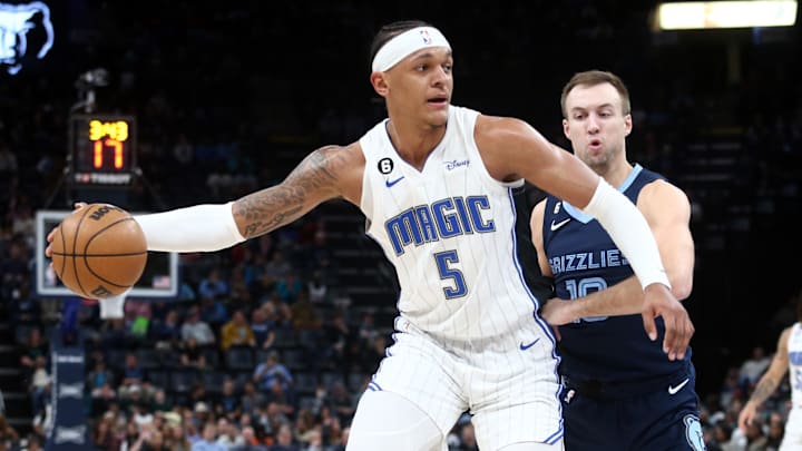 Mar 28, 2023; Memphis, Tennessee, USA; Orlando Magic forward Paolo Banchero (5) handles the ball as Memphis Grizzlies guard Luke Kennard (10) defends during the first half at FedExForum. Mandatory Credit: Petre Thomas-Imagn Images