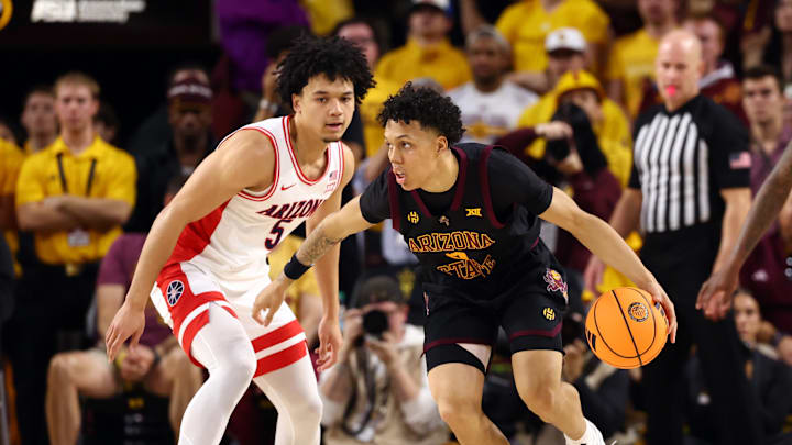 Jan 31, 2026; Tempe, Arizona, USA; Arizona State Sun Devils guard Bryce Ford (4) controls the ball against Arizona Wildcats guard Brayden Burries (5) in the first half at Desert Financial Arena. Mandatory Credit: Mark J. Rebilas-Imagn Images
