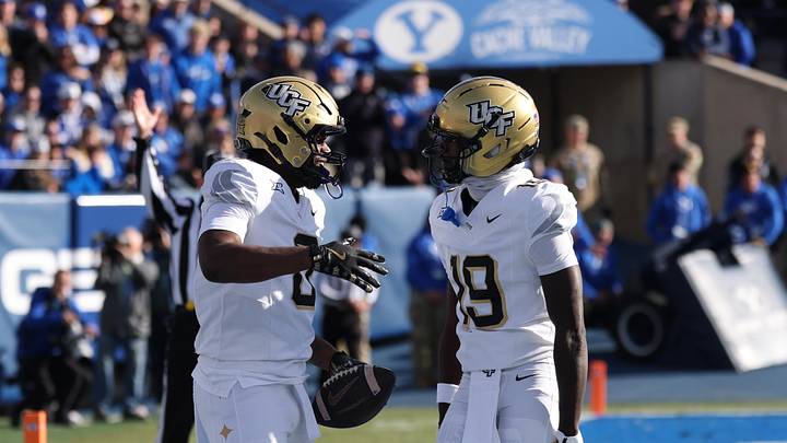 Nov 29, 2025; Provo, Utah, USA; UCF Knights tight end Dylan Wade (0) scores a touchdown against the BYU Cougars and celebrates with UCF Knights wide receiver Waden Charles (19) during the first quarter at LaVell Edwards Stadium. Mandatory Credit: Rob Gray-Imagn Images