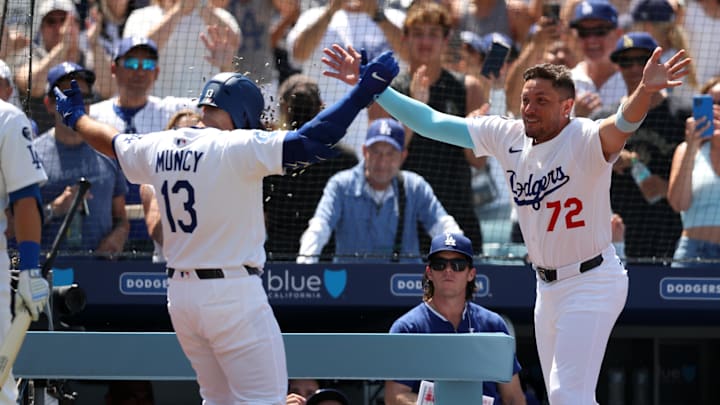 Jun 22, 2025; Los Angeles, California, USA;  Los Angeles Dodgers third baseman Max Muncy (13) celebrates with shortstop Miguel Rojas (72) after hitting a grand slam during the sixth inning against the Washington Nationals at Dodger Stadium. Mandatory Credit: Kiyoshi Mio-Imagn Images