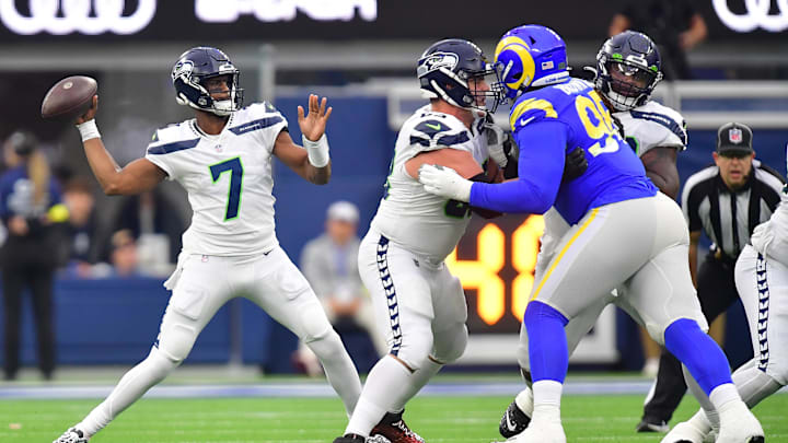 Dec 4, 2022; Inglewood, California, USA; Seattle Seahawks quarterback Geno Smith (7) throws as guard Austin Blythe (63) provides coverage against Los Angeles Rams defensive tackle Bobby Brown III (95) during the first half at SoFi Stadium. Mandatory Credit: Gary A. Vasquez-Imagn Images Dec 4, 2022; Inglewood, California, USA; Seattle Seahawks quarterback Geno Smith (7) throws as guard Austin Blythe (63) provides coverage against Los Angeles Rams defensive tackle Bobby Brown III (95) during the first half at SoFi Stadium. Mandatory Credit: Gary A. Vasquez-Imagn Images
