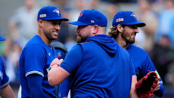Sep 11, 2025; Toronto, Ontario, CAN; Toronto Blue Jays designated hitter George Springer (left) and manager John Schneider (center) and starting pitcher Kevin Gausman (right) celebrate a win over the Houston Astros at Rogers Centre. Mandatory Credit: John E. Sokolowski-Imagn Images