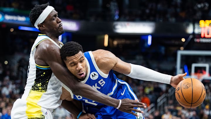 Mar 11, 2025; Indianapolis, Indiana, USA; Milwaukee Bucks forward Giannis Antetokounmpo (34) dribbles the ball while  Indiana Pacers forward Pascal Siakam (43) defends in the second half  at Gainbridge Fieldhouse. Mandatory Credit: Trevor Ruszkowski-Imagn Images