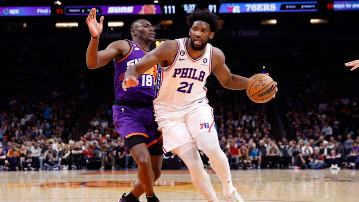 Mar 25, 2023; Phoenix, Arizona, USA; Philadelphia 76ers center Joel Embiid (21) drives on Phoenix Suns center Bismack Biyombo (18) during the game at Footprint Center. Mandatory Credit: Chris Coduto-Imagn Images