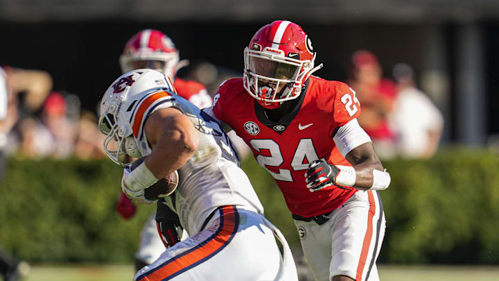 Oct 8, 2022; Athens, Georgia, USA; Auburn Tigers tight end John Samuel Shenker (25) is tackled by Georgia Bulldogs defensive back Malaki Starks (24) during the first half at Sanford Stadium. Mandatory Credit: Dale Zanine-Imagn Images