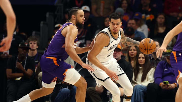 Jan 27, 2026; Phoenix, Arizona, USA; Brooklyn Nets forward Michael Porter Jr. (17) against Phoenix Suns forward Dillon Brooks (3) in the first half at Mortgage Matchup Center. Mandatory Credit: Mark J. Rebilas-Imagn Images
