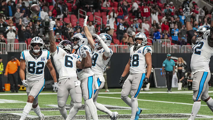 Jan 5, 2025; Atlanta, Georgia, USA; Carolina Panthers running back Miles Sanders (6) reacts with teammates after scoring the game winning touchdown against the Atlanta Falcons in overtime at Mercedes-Benz Stadium. Mandatory Credit: Dale Zanine-Imagn Images