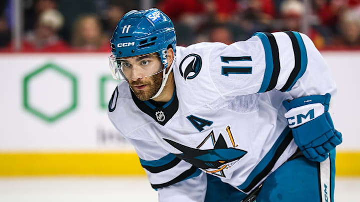 Feb 23, 2025; Calgary, Alberta, CAN; San Jose Sharks center Luke Kunin (11) during the face off against the Calgary Flames during the third period at Scotiabank Saddledome. Mandatory Credit: Sergei Belski-Imagn Images