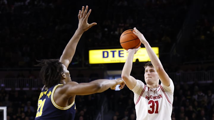 Jan 10, 2026; Ann Arbor, Michigan, USA;  Wisconsin Badgers forward Nolan Winter (31) shoots on Michigan Wolverines forward Morez Johnson Jr. (21) in the second half at Crisler Center.