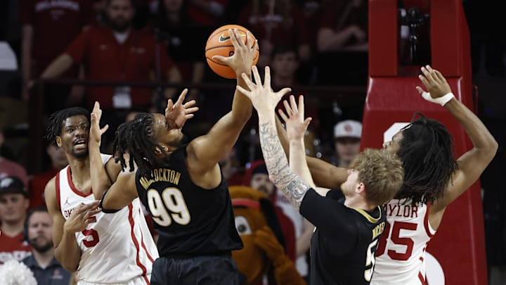 Feb 1, 2025; Norman, Oklahoma, USA; Vanderbilt Commodores forward Devin McGlockton (99) fights for control of the ball against Oklahoma Sooners forward Mohamed Wague (5) and forward Glenn Taylor Jr. (35) during the first half at Lloyd Noble Center. Mandatory Credit: Alonzo Adams-Imagn Images Feb 1, 2025; Norman, Oklahoma, USA; Vanderbilt Commodores forward Devin McGlockton (99) fights for control of the ball against Oklahoma Sooners forward Mohamed Wague (5) and forward Glenn Taylor Jr. (35) during the first half at Lloyd Noble Center. Mandatory Credit: Alonzo Adams-Imagn Images