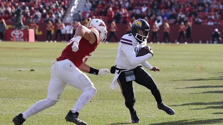 Nov 22, 2025; Ames, Iowa, USA; Kansas Jayhawks quarterback Jalon Daniels (6) is pursued by Iowa State Cyclones linebacker Caleb Bacon (26) during the second half at Jack Trice Stadium. Mandatory Credit: Reese Strickland-Imagn Images