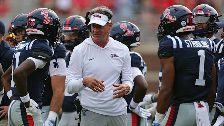 Sep 20, 2025; Oxford, Mississippi, USA; Mississippi Rebels head coach Lane Kiffin (middle) talks with wide receivers Deuce Alexander (11) and De'Zhaun Stribling (1) during a time out during the second quarter against the Tulane Green Wave at Vaught-Hemingway Stadium. Mandatory Credit: Petre Thomas-Imagn Images