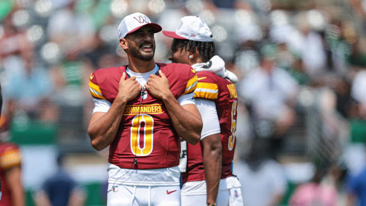 Aug 10, 2024; East Rutherford, New Jersey, USA; Washington Commanders quarterback Marcus Mariota (0) looks on during the first half against the New York Jets at MetLife Stadium. Mandatory Credit: Vincent Carchietta-Imagn Images