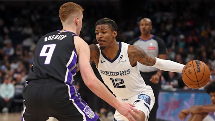 Dec 5, 2024; Memphis, Tennessee, USA; Memphis Grizzlies guard Ja Morant (12) drives to the basket as Sacramento Kings guard Kevin Huerter (9) defends during the second quarter at FedExForum. Mandatory Credit: Petre Thomas-Imagn Images