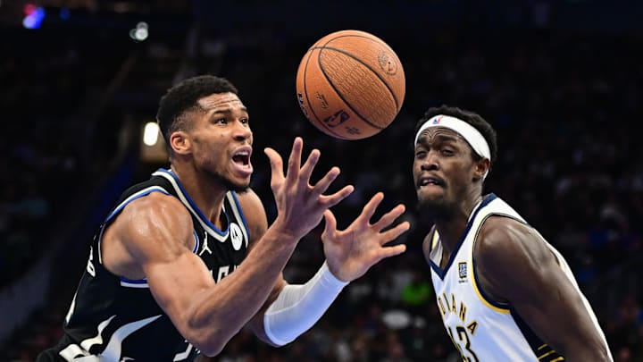 Nov 22, 2024; Milwaukee, Wisconsin, USA; Milwaukee Bucks forward Giannis Antetokounmpo (34) and Indiana Pacers forward Pascal Siakam (43) reach for a loose ball in the fourth quarter at Fiserv Forum. Mandatory Credit: Benny Sieu-Imagn Images