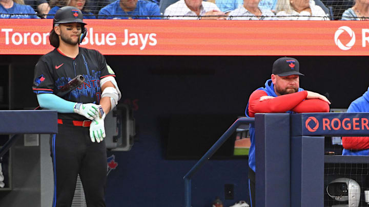 Toronto Blue Jays short stop Bo Bichette (11) and Manager John Schneider (14) in the dugout in the fourth inning against the Houston Astros  at Rogers Centre on July 3.