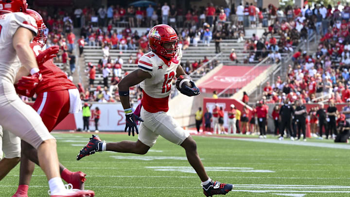 Oct 18, 2025; Houston, Texas, USA; Arizona Wildcats wide receiver Tre Spivey (12) runs the ball in for a touchdown during the fourth quarter against the Houston Cougars at TDECU Stadium. Mandatory Credit: Maria Lysaker-Imagn Images Oct 18, 2025; Houston, Texas, USA; Arizona Wildcats wide receiver Tre Spivey (12) runs the ball in for a touchdown during the fourth quarter against the Houston Cougars at TDECU Stadium. Mandatory Credit: Maria Lysaker-Imagn Images
