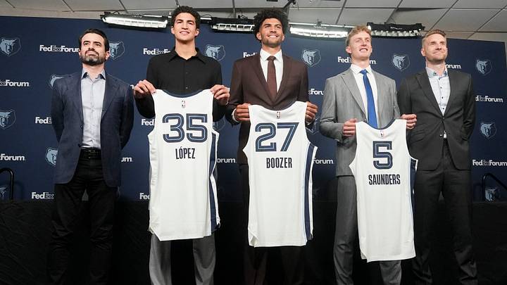 Grizzlies 2026 draft picks Karim Lopez, Cam Boozer and Richie Saunders pose for photos with their New Jerseys next to Zach Kleiman, general manager and executive vice president of basketball operations, and head coach Tuomas Iisalo after the players’ introductory press conference at FedExForum in Memphis, Tenn., on June 25, 2026.