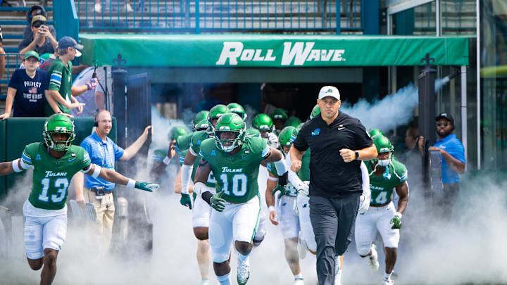 Aug 30, 2025; New Orleans, Louisiana, USA; Tulane Green Wave head coach Jon Sumrall runs out the tunnel with defensive end Gerrod Henderson (10) and safety Tavare Smith (13) against Northwestern Wildcats during the first half at Yulman Stadium. Mandatory Credit: Stephen Lew-Imagn Images Aug 30, 2025; New Orleans, Louisiana, USA; Tulane Green Wave head coach Jon Sumrall runs out the tunnel with defensive end Gerrod Henderson (10) and safety Tavare Smith (13) against Northwestern Wildcats during the first half at Yulman Stadium. Mandatory Credit: Stephen Lew-Imagn Images