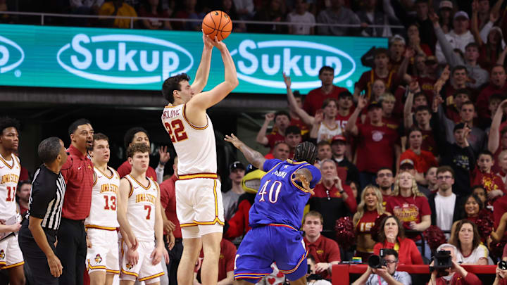 Feb 14, 2026; Ames, Iowa, USA;  Iowa State Cyclones forward Milan Momcilovic (22) shoots over Kansas Jayhawks forward Flory Bidunga (40) during the second half at James H. Hilton Coliseum. Mandatory Credit: Reese Strickland-Imagn Images