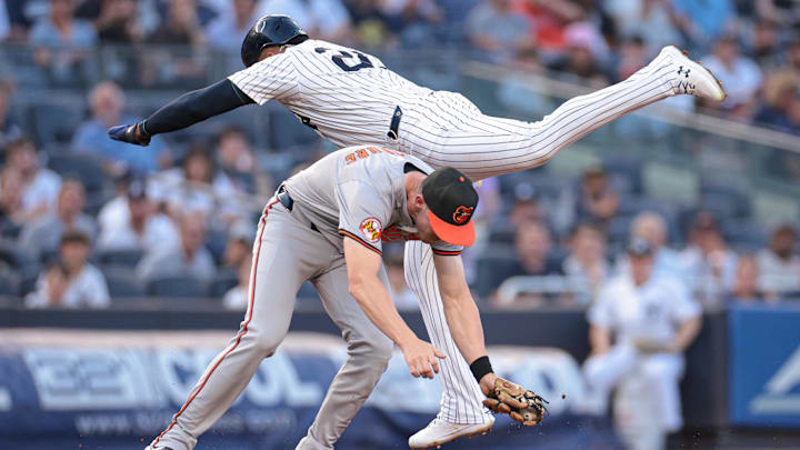 Jun 18, 2024; Bronx, New York, USA; New York Yankees right fielder Juan Soto (22) interferes with Baltimore Orioles third baseman Jordan Westburg (11) during the first inning at Yankee Stadium. Mandatory Credit: Vincent Carchietta-USA TODAY Sports